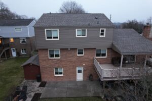 Complete exterior renovation in Bethel Park featuring Montana Suede siding and CertainTeed Pro Shingles.